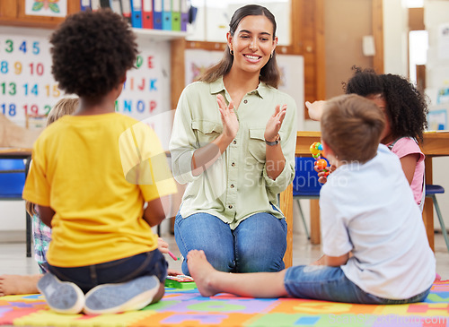 Image of Diversity, teacher with children at school and playing together in a classroom at. Teaching or learning, education or collaboration and happy female person with preschool kids play on floor in class