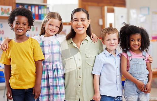 Image of Education, portrait of teacher with children and in a classroom of a school. Diversity or support, happiness or caring and smiling female person with kids at kindergarten in a class together.