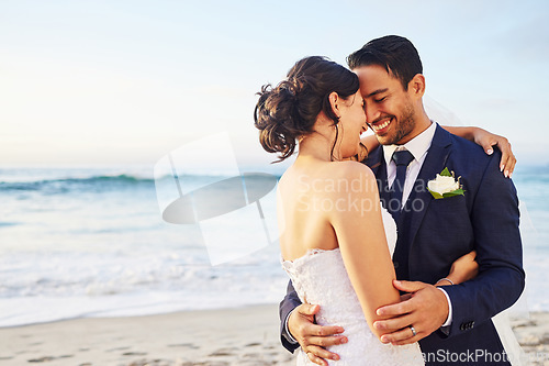 Image of Wedding day, hug and couple at a beach for love, union and celebration against a nature background. Summer, marriage and happy groom with bride embracing at sea ceremony, smile and romantic in Bali