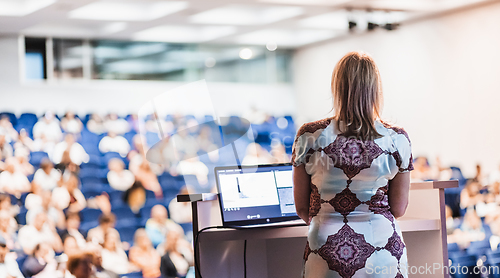 Image of Public speaker giving talk at Business Event.