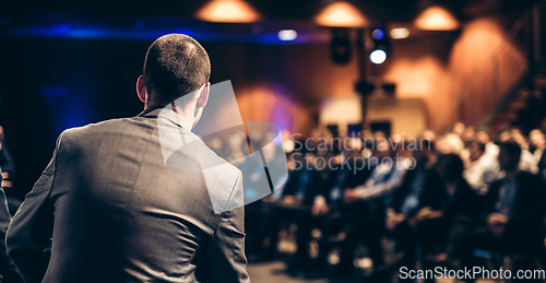 Image of Public speaker giving talk at Business Event.