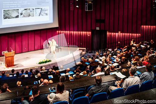 Image of Woman giving presentation on business conference event.