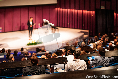 Image of Woman giving presentation on business conference event.