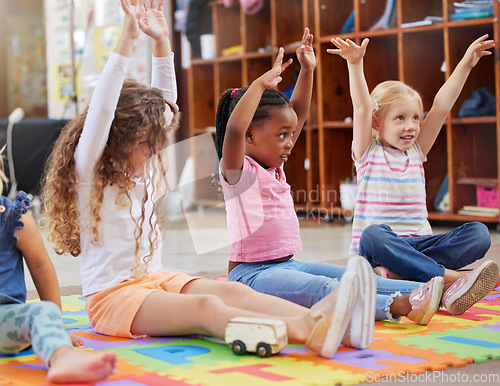 Image of Education, raise hands and children in kindergarten in a classroom for education or knowledge. Daycare, happy and young kid students with a question gesture for learning in lesson together at nursery