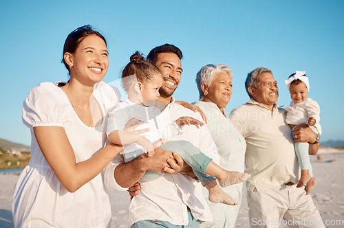 Image of Happy, big family and relax on beach for holiday, weekend or fun vacation together in the nature outdoors. Grandparents, parents and kids with smile on ocean coast for travel or bonding in happiness