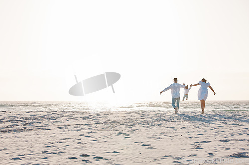 Image of Family, holding hands and playing on beach with mockup space for holiday weekend or vacation. Mother, father and child enjoying quality play time together for fun bonding or travel in nature outdoors