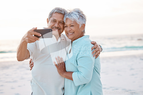 Image of Senior couple, hug and beach for selfie, profile picture or online post together in nature. Happy elderly man and woman smiling on ocean coast for photo, memory or social media vlog in the outdoors