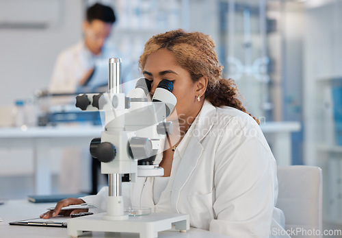 Image of Science, research and microscope with a woman at work in a laboratory for innovation or investigation. Healthcare, medical and experiment with a female scientist working in a lab for pharmaceuticals