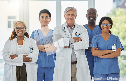 Image of Happy portrait, arms crossed and group of doctors standing together in hospital. Face, teamwork and confident medical professionals, nurses and surgeons with collaboration, healthcare and support.