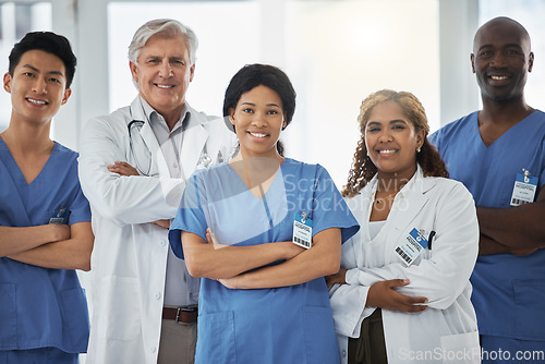 Image of Smile, portrait and team of doctors with arms crossed standing together in hospital. Face, confident or medical professionals, nurses or surgeon group with healthcare collaboration, teamwork or trust