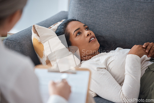 Image of Therapist, psychology and woman lying on sofa in consultation for mental health. Therapy, psychologist and female patient consulting, counseling and thinking about depression, problem and talking.