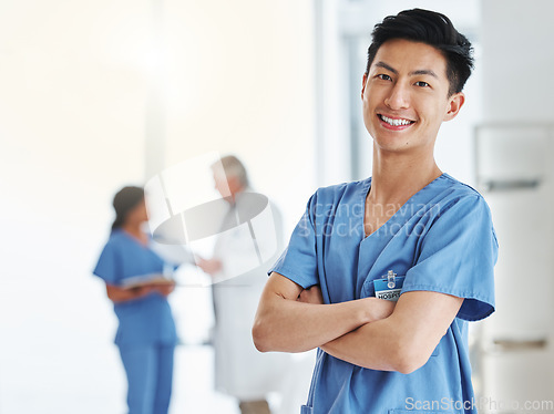 Image of Portrait, happy man and Asian nurse with arms crossed in hospital or clinic. Face, confidence and medical professional, male surgeon or doctor with pride for career, job and healthcare for wellness.