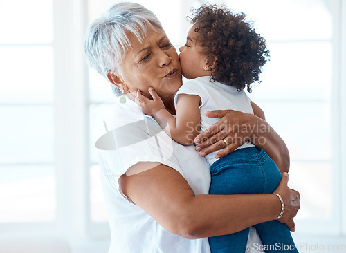 Image of Love, kiss and grandmother with child in a living room for bonding, hug and playing in their home. Kissing, family and senior female enjoying retirement with grandchild, babysitting and hugging