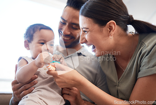 Image of Happy family, baby and parents laughing, funny and excited for quality time, bonding and home development of child. Mother, father and girl or kid with dad, mom or people and toys, love and care
