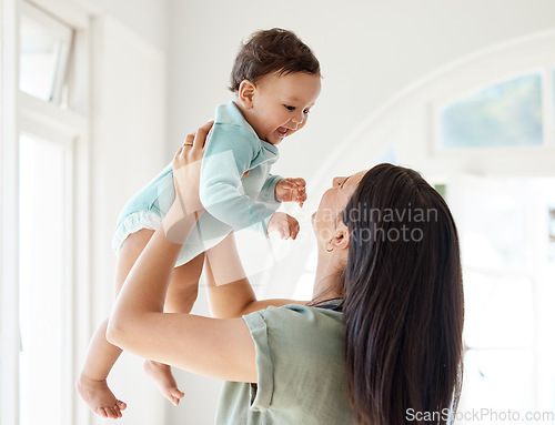 Image of Mom carrying happy baby in home for love, care and quality time together to nurture childhood development. Mother, playing and holding infant kid for support, happiness and funny laughing in house