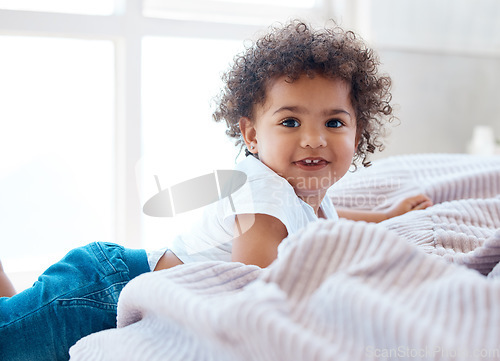 Image of Portrait, toddler girl and smile in bedroom for happiness, childhood development and growth with curly hair. Cute, adorable and sweet young child, happy kid and relax in comfortable nursery at home