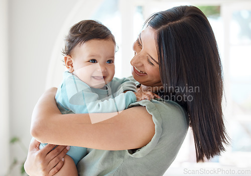 Image of Mother holding happy baby in home for love, care and quality time together to nurture childhood development. Mom, infant kid and carrying little girl for support, happiness and smile with fun parent