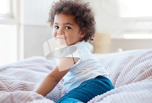 Image of Happy portrait, girl and kid in bedroom for fun, childhood development and baby growth with curly hair. Cute, adorable and sweet toddler, young child or relaxing on comfortable bed in nursery at home