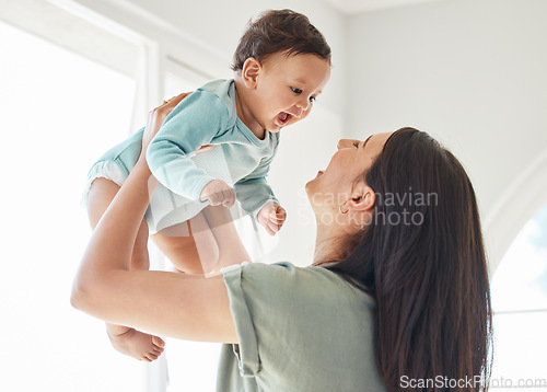 Image of Mother holding laughing baby in home for love, care and quality time together to nurture childhood development. Happy mom, carrying and playing with infant girl kid for support, happiness and fun