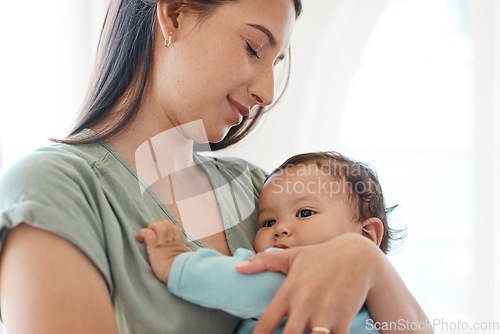 Image of Mother holding baby in arms for love, care and quality time together to nurture childhood development at home. Mom carrying infant girl kid, young child and newborn for support, comfort and childcare