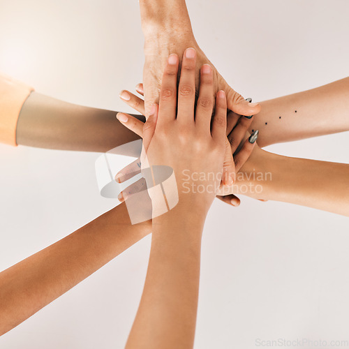 Image of Hands stacked, teamwork and women in support, collaboration goals and community or solidarity from above. Circle, group of people and team work, faith or together sign isolated on a white background