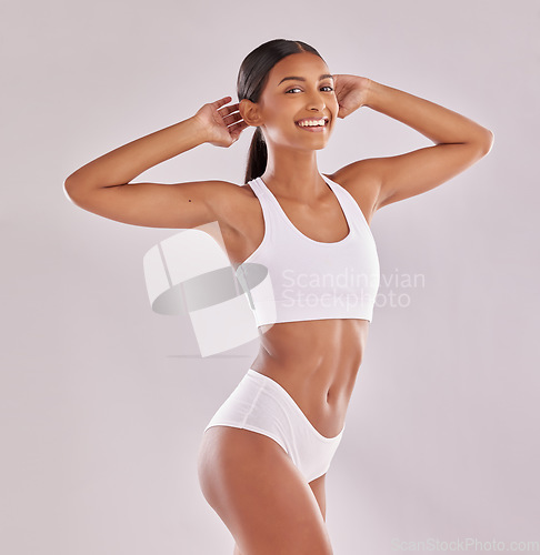 Image of Woman in underwear, smile in portrait with body and fitness, health and skin isolated on studio background. Happy female model, abdomen and healthy lifestyle with wellness and person lose weight