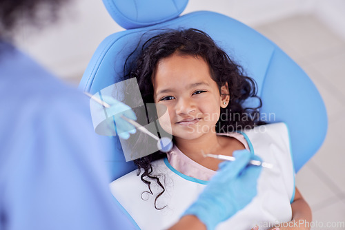 Image of Dentistry, portrait and girl child at the dentist for teeth cleaning, oral checkup or consultation. Healthcare, smile and kid laying on the chair for dental mouth examination with equipment in clinic