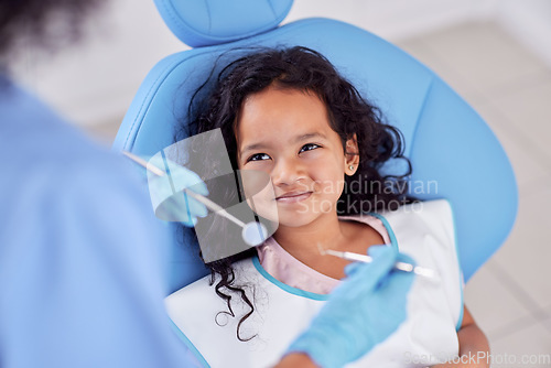 Image of Dentistry, happy and kid patient at dentist for teeth cleaning, oral checkup or consultation. Healthcare, smile and girl child laying on chair for dental mouth examination with equipment in a clinic.
