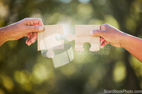 Image of Hands, puzzle piece and outdoor with sustainability, eco friendly and agriculture development. Growth, collaboration and farm planning with farmer hand and bokeh in nature to connect with synergy