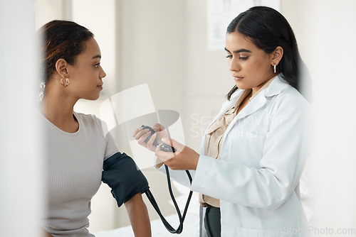 Image of Healthcare, blood pressure and doctor with a patient for a consultation in the hospital. Medicine, equipment and medical worker checking hypertension of a woman at a checkup in a medicare clinic.