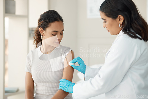 Image of Healthcare, cotton and arm for vaccine at the hospital for safety or cure for virus or disease. Doctor, clinic and patient before vaccination for consultation with gloves for medical care and help.