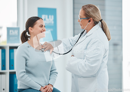 Image of Healthcare, doctor exam with woman patient and consultation with stethoscope at a hospital. Medicine or health wellness, cardiology and surgeon medical test with a female person in a clinic building