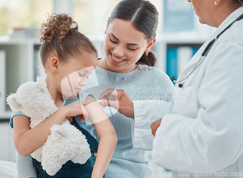 Image of Mom, girl and doctor with vaccine injection, cotton ball and flu shot on arm for disease prevention in hospital. Woman, pediatrician or nurse and immunity of child against virus, bacteria or covid