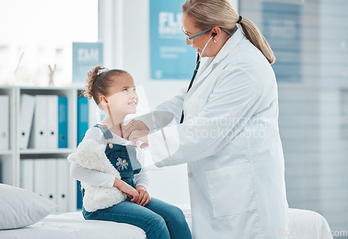 Image of Health wellness, doctor exam with child patient and consultation with stethoscope at a clinic. Cardiology or healthcare, medicine and surgeon medical test with a female kid in a hospital building