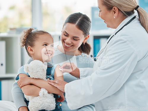 Image of Pediatrician, girl and doctor with vaccine injection, cotton ball and flu shot on arm for disease or covid prevention in hospital. Woman, nurse and immunity of child against virus, bacteria or happy