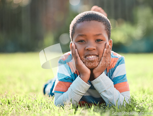 Image of Nature park, portrait of black boy and lying on grass outside. Summer vacation or holiday break, happiness or cheerful and barefoot with young male person relaxing on a field outdoors on lawn