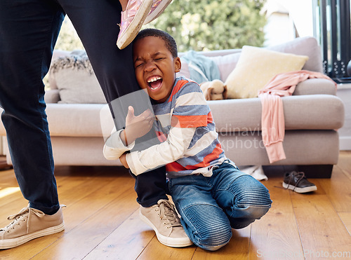 Image of Tantrum, home and boy on leg of father shouting with anger, frustrated and upset emotions. Family, discipline and naughty child holding parent scream with mess, clothes and chaos in living room