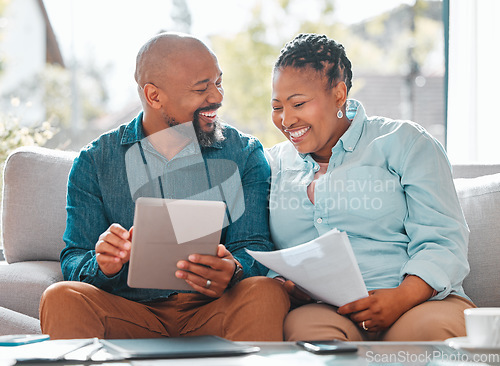 Image of Finance, married couple with tablet and documents for pay their bills online n a living room of their home. Technology or loan, budget or payment and happy people with paper on a couch together