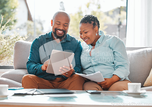 Image of Technology, married couple with tablet and documents for pay their bills in a living room of their home. Finance or loan, budget or payment and black people with paper on a couch happy together