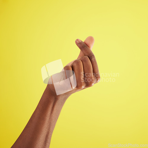 Image of Hand, gesture for money and sign language of man closeup on studio background for cash, finance or currency. Person, thumb and index fingers rubbing together or symbol to pay, payment and poor