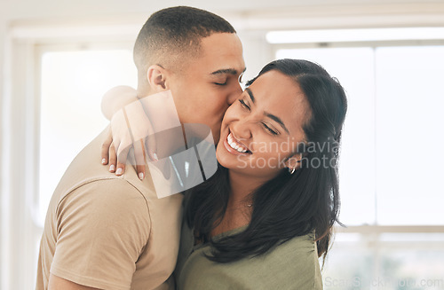 Image of Couple, love and kiss in home for happy romance, intimacy and relax while bonding together. Young man, woman and kissing partner in relationship, quality time and smile for care, trust and happiness