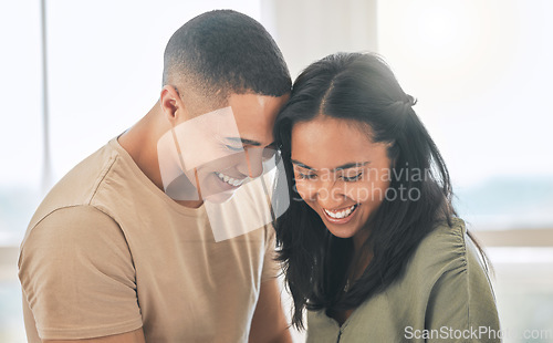 Image of Couple, smile and laughing in home for love, intimacy and relax for romance, bonding and trust together. Young man, woman and happy partner with care, quality time or happiness in loving relationship