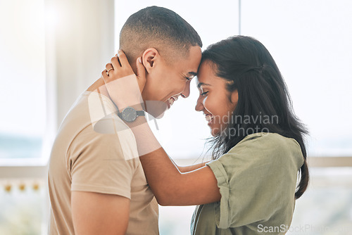 Image of Couple, love and forehead touch in home for happiness, intimacy and relax for romance, bonding and trust together. Happy man, woman and hug partner for quality time, care and smile for commitment