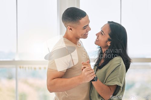 Image of Happy, couple and dance in home for love, care and support of relationship, trust and quality time together. Man, woman and dancing with partner in fun, happiness or celebrate of romantic anniversary