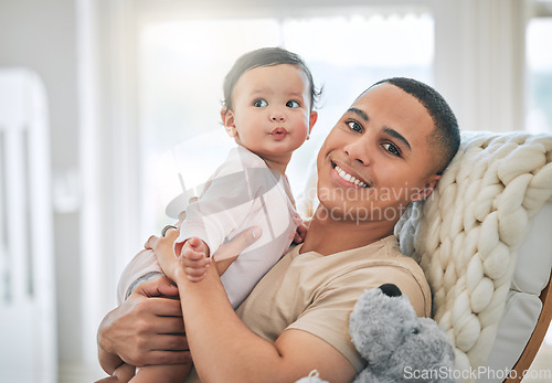 Image of Father, holding baby and portrait in a family home for bonding, security and quality time. Man or dad and girl child relax together on a sofa for development, trust and support or care with a smile