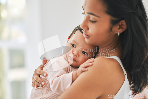 Image of Mother, holding baby and love in a family home for bonding, security and quality time. Woman or mom and girl child relax together in a house for development, trust and support or care on mothers day