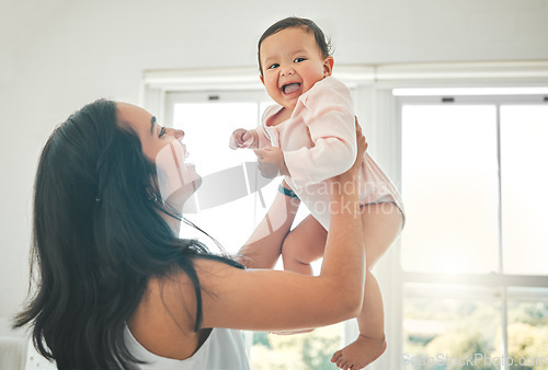 Image of Funny, mother and lifting baby, care and bonding together with infant in home. Smile, mama and raise newborn, child or kid, playing and having fun, happiness or enjoying quality time with family love