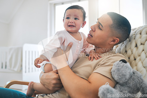Image of Father, holding baby and crying in a family home while hungry, tired or sad. Frustrated and confused man or dad and girl child cry on a sofa while sick, colic or sleepy on a living room couch