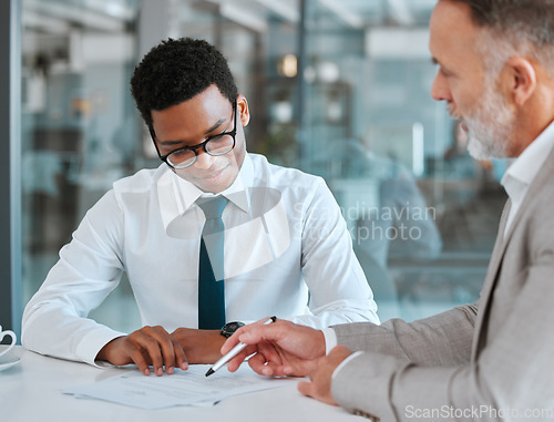 Image of Human resources, interview and documents with a business man and candidate for a vacancy meeting in an office. Manager, recruitment or hiring with hr reading an employment contract in the boardroom