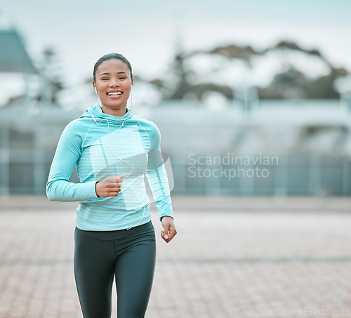 Image of Portrait, city or black woman running, exercise or training with earphones, health or cardio. Face, female person or runner with motivation, workout goal or practice with wellness, outdoor or fitness